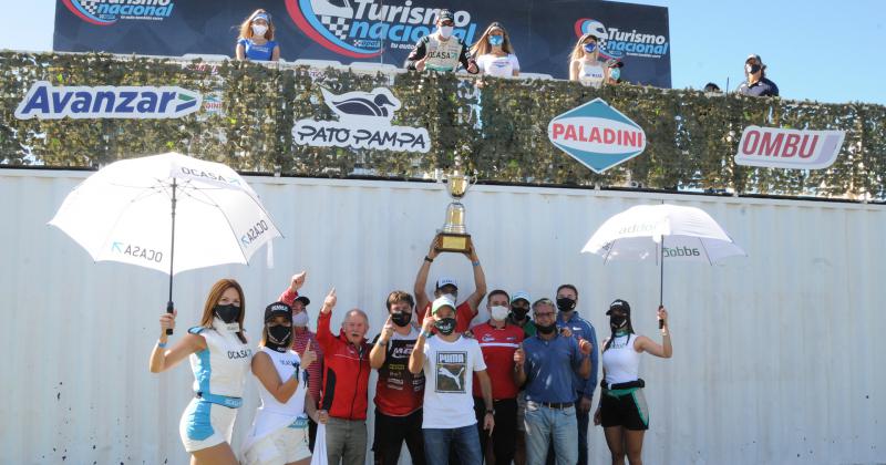 Los integrantes del equipo festejan abajo del podio el triunfo de Pernía